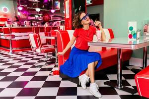 stylish smiling woman in retro vintage cafe photo