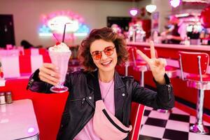 stylish smiling woman in retro vintage cafe photo