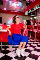 stylish smiling woman in retro vintage cafe photo