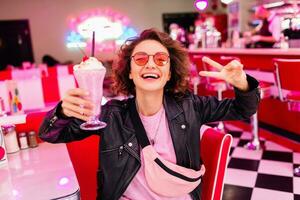 stylish smiling woman in retro vintage cafe photo