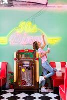 stylish smiling woman in retro vintage cafe photo