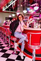 stylish smiling woman in retro vintage cafe photo