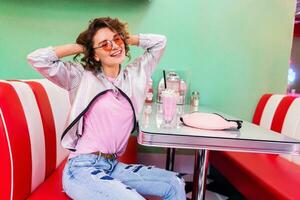 stylish smiling woman in retro vintage cafe photo