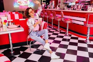 stylish smiling woman in retro vintage cafe photo