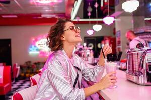 stylish smiling woman in retro vintage cafe photo