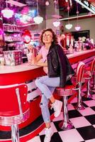 stylish smiling woman in retro vintage cafe photo