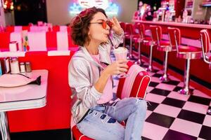 stylish smiling woman in retro vintage cafe photo