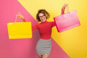 exited attractive woman in stylish colorful outfit holding shopping bags photo