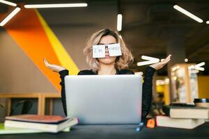 young woman working on laptop in co-working office photo