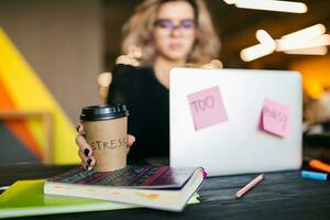 young woman working on laptop in co-working office photo