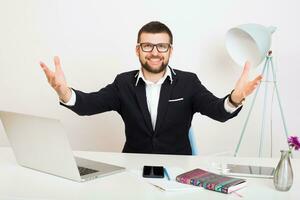 young handsome stylish hipster man in black jacket working at office table photo