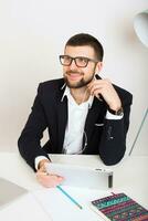 young handsome stylish hipster man in black jacket working at office table photo
