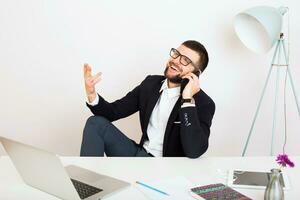 young handsome stylish hipster man in black jacket working at office table photo