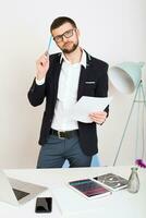 young handsome stylish hipster man in black jacket working at office table photo