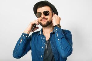 young handsome happy smiling man listening to music in earphones photo