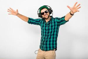 young handsome happy smiling man dancing and listening to music in headphones photo