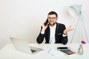 young handsome stylish hipster man in black jacket working at office table, business style photo