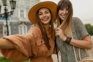 stylish young women traveling together photo