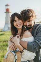 laughing young hipster couple indie style in love walking in countryside photo