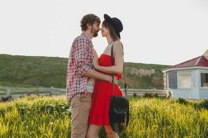 young stylish couple in love in countryside, indie hipster bohemian style photo