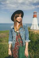 young woman in nature, bohemian outfit, denim jacket photo