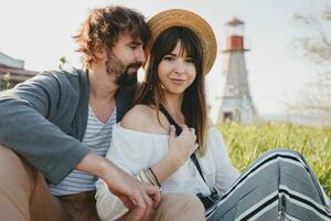 romantic young hipster couple indie style in love walking in countryside photo