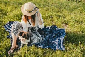 bonito elegante mujer en campo, participación un perro foto