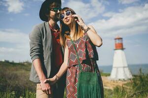smiling holding hands young hipster couple indie style in love walking in countryside photo