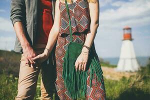 smiling holding hands young hipster couple indie style in love walking in countryside photo