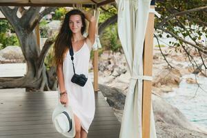 young natural beautiful woman in pale gown, tropical vacation photo