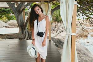 young natural beautiful woman in pale gown, tropical vacation photo