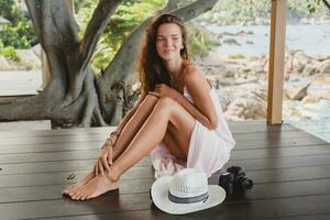 young natural beautiful woman in pale gown, tropical vacation photo