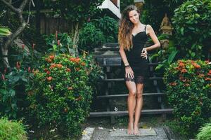 young beautiful woman in tropical garden photo