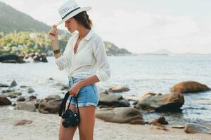 young beautiful hipster woman on summer vacation photo