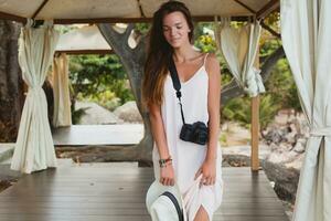 young natural beautiful woman in pale gown, tropical vacation photo