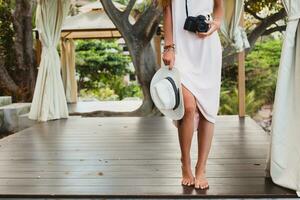 young natural beautiful woman in pale gown, tropical vacation photo