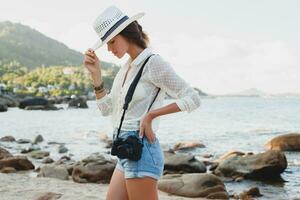 young beautiful hipster woman on summer vacation photo