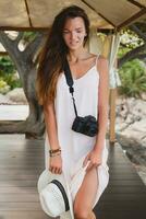 young natural beautiful woman in pale gown, tropical vacation photo