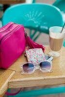 objects arranged on table in city cafe in street, woman accessories photo