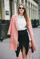 young stylish beautiful woman walking in street photo