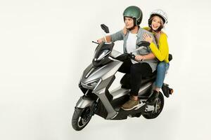 young attractive couple riding an electric motorbike scooter happy having fun together photo