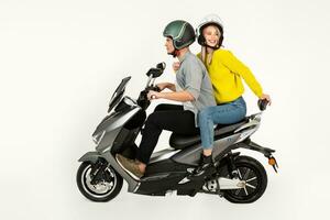 young attractive couple riding an electric motorbike scooter happy having fun together photo