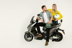 young attractive couple riding an electric motorbike scooter happy having fun together photo