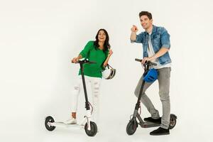 a couple riding on electic kick scooter isolated on white studio background photo