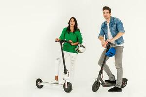 a couple riding on electic kick scooter isolated on white studio background photo