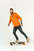 young hipster style man skateboarding on electric skateboard photo