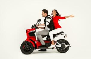 young attractive couple riding an electric motorbike scooter happy having fun together photo