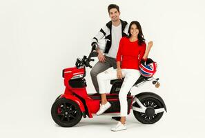 young attractive couple riding an electric motorbike scooter happy having fun together photo