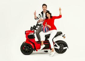 young attractive couple riding an electric motorbike scooter happy having fun together photo