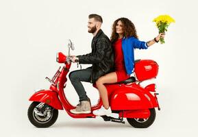 young attractive couple riding an electric motorbike scooter happy having fun together photo